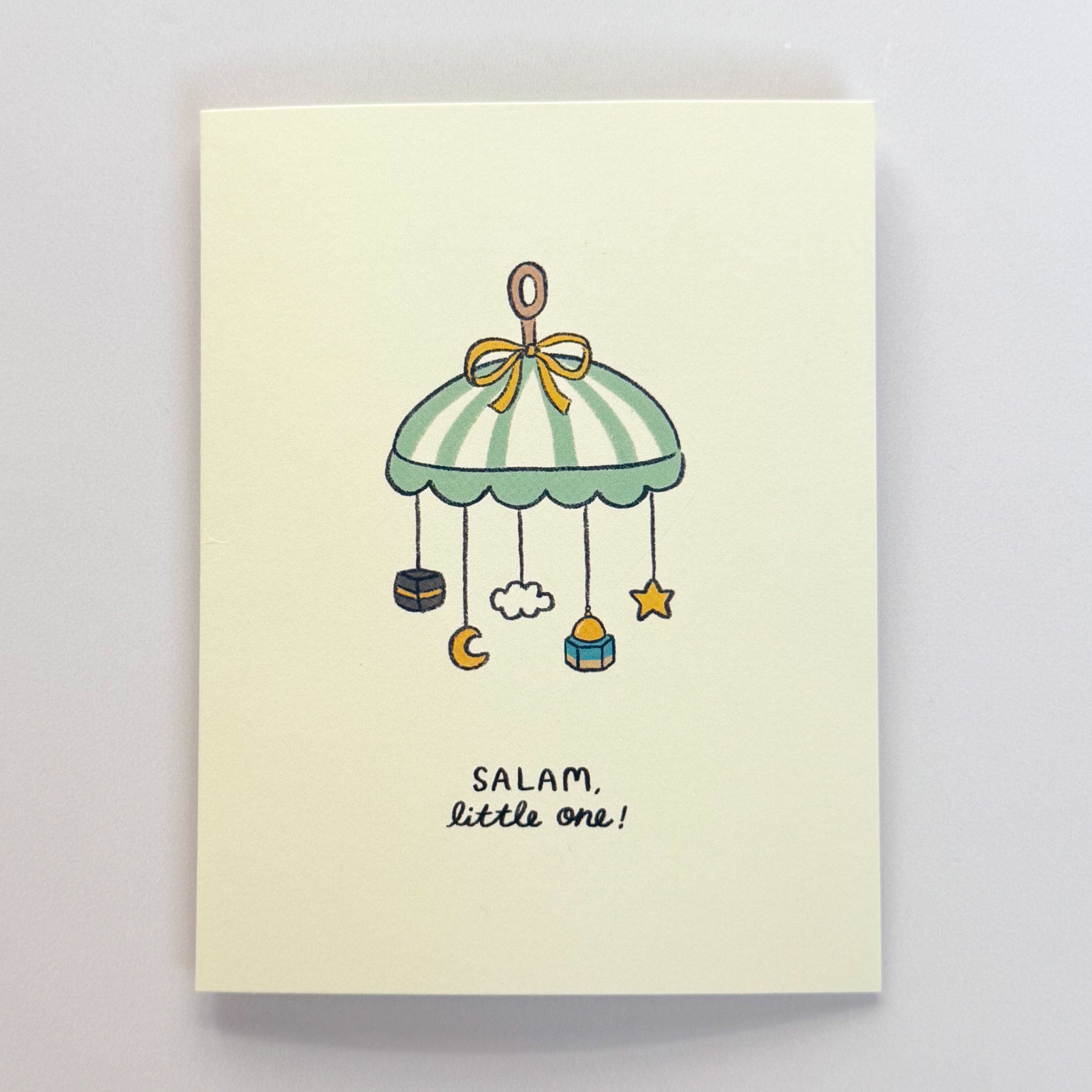 Card with a baby mobile illustration and 'Salam, little one!' text on a light background